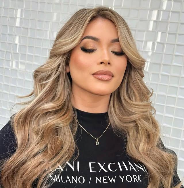 Long, wavy hairstyle with a balayage, layered with face framing.