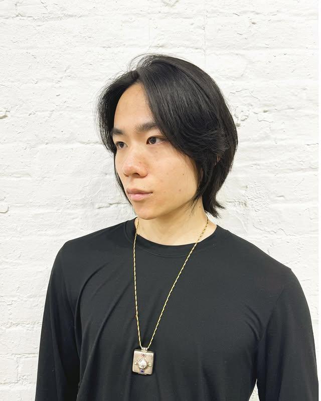 Korean flow haircut with a medium length, layered cut and soft waves.