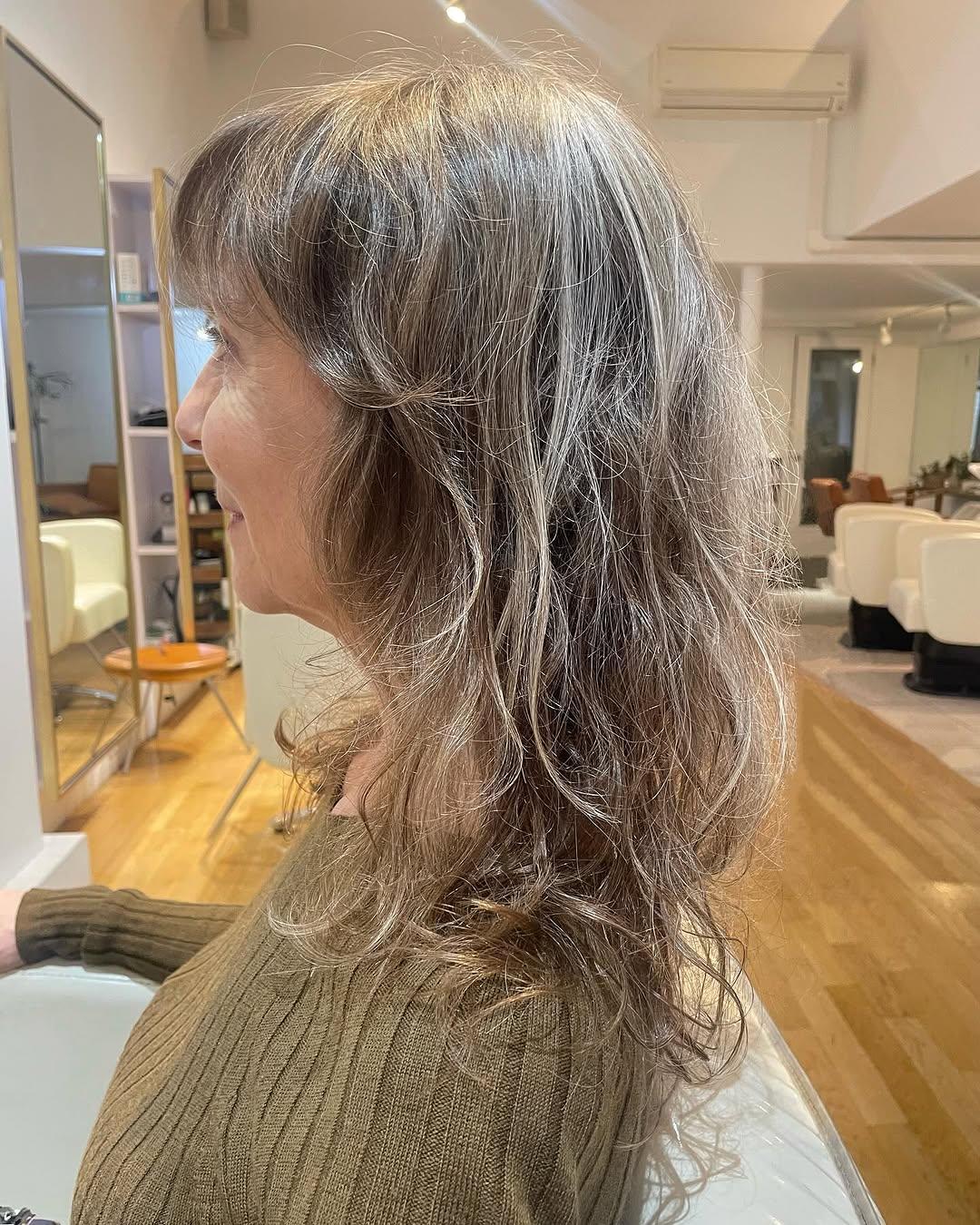 A textured, shoulder-length lob with face-framing layers to add softness.
