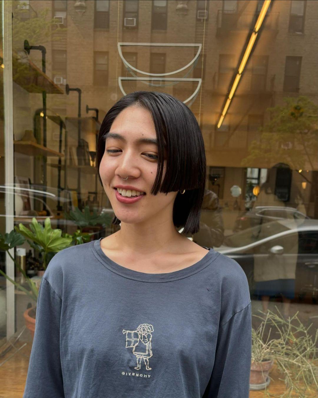 A sleek, asymmetrical bob with sharp edges, chin length, straight texture, and a smooth, polished finish. haircut by @takeohair 3