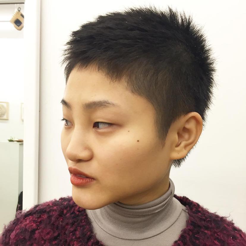 A classic crewcut with very short, straight black hair, designed for a bold and confident look.