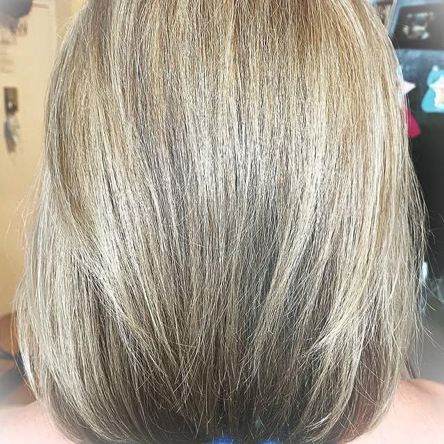 Layered blonde bob with subtle layers adding texture and volume to straight hair.