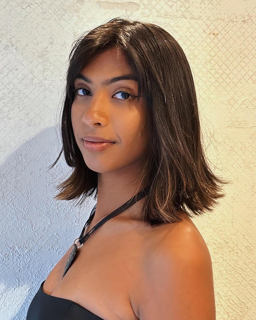Medium-length, sleek bob with glossy, dark brown hair and soft layers in a subtle A-line cut. 1
