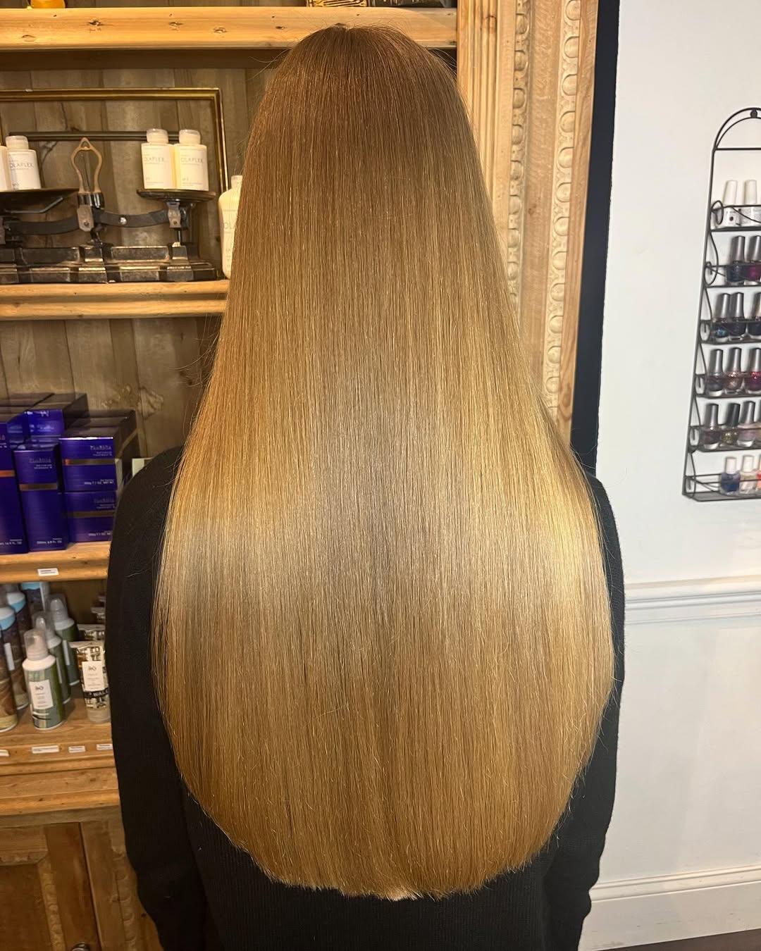 Very long, straight blonde hair with a smooth texture and even cut, showcasing natural shine and full volume. 1