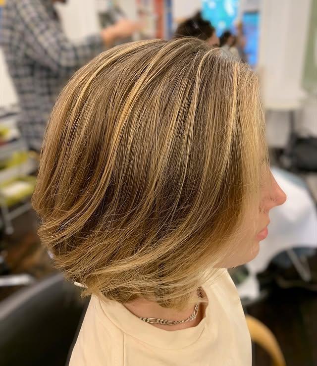 Modern layered bob with highlights, adding movement and dimension to straight hair for a fuller look.