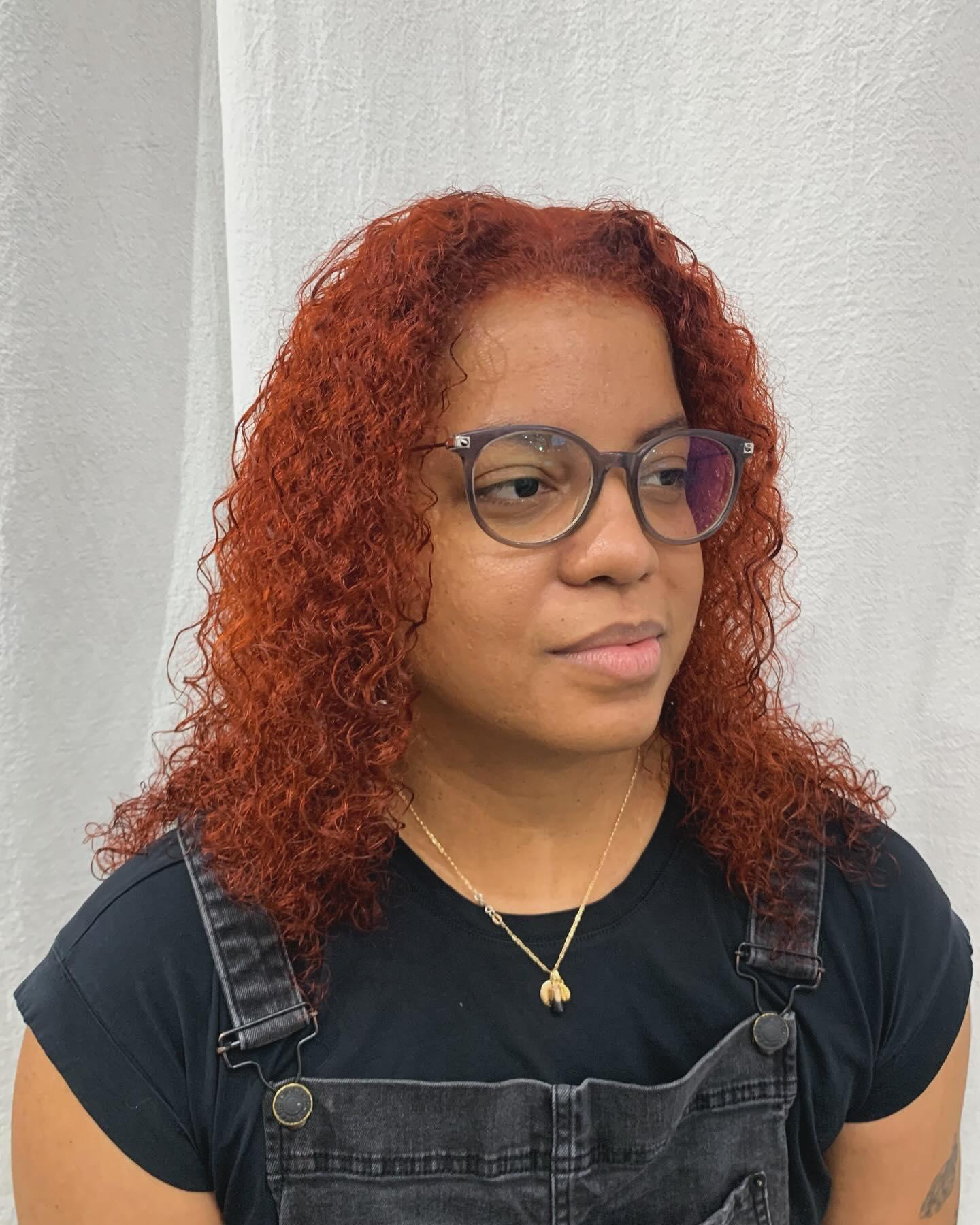 Medium-length curly hair in bold red and copper, with defined curls and voluminous texture. 3