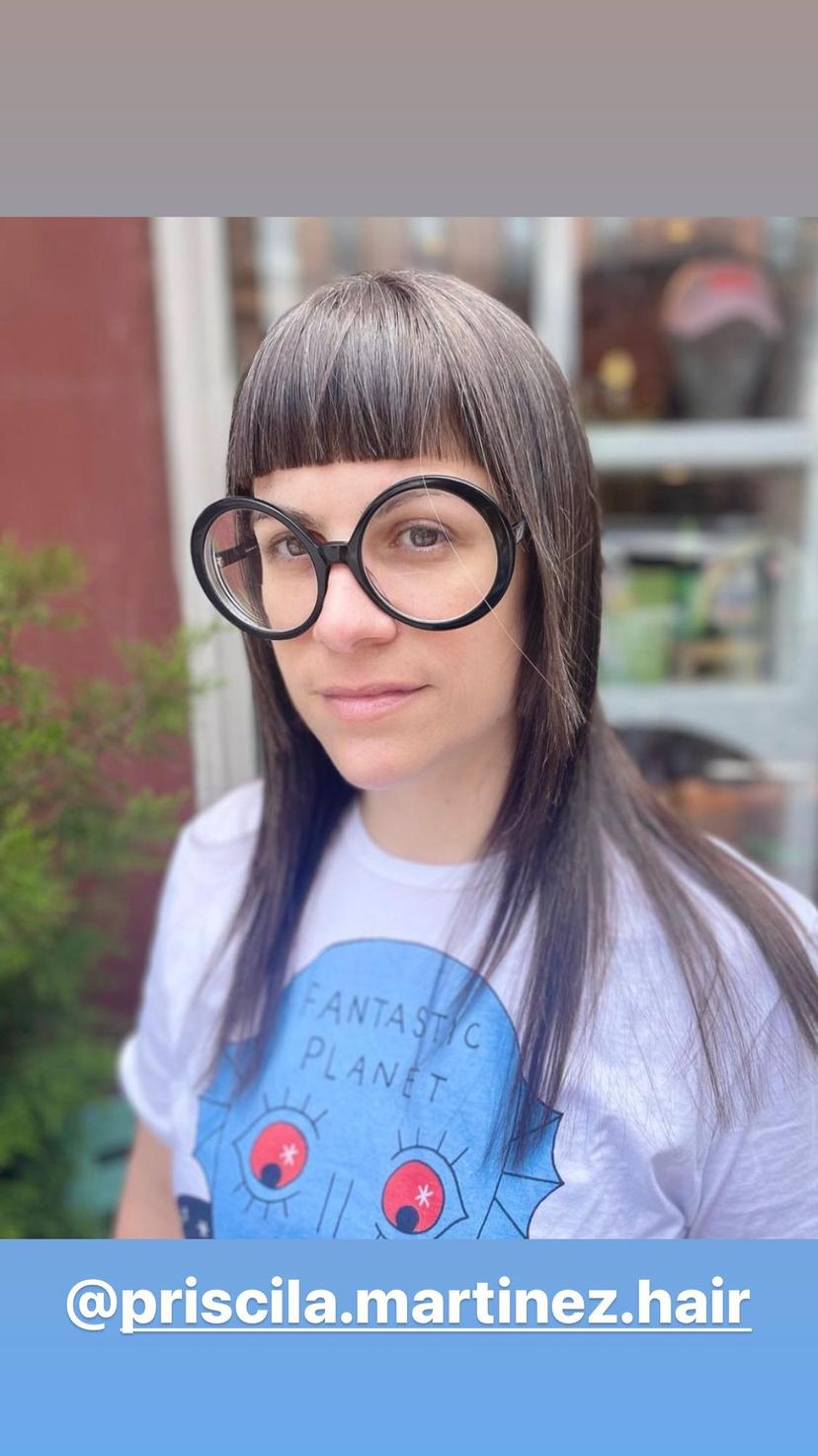 Layered shag haircut with bold, blunt bangs.