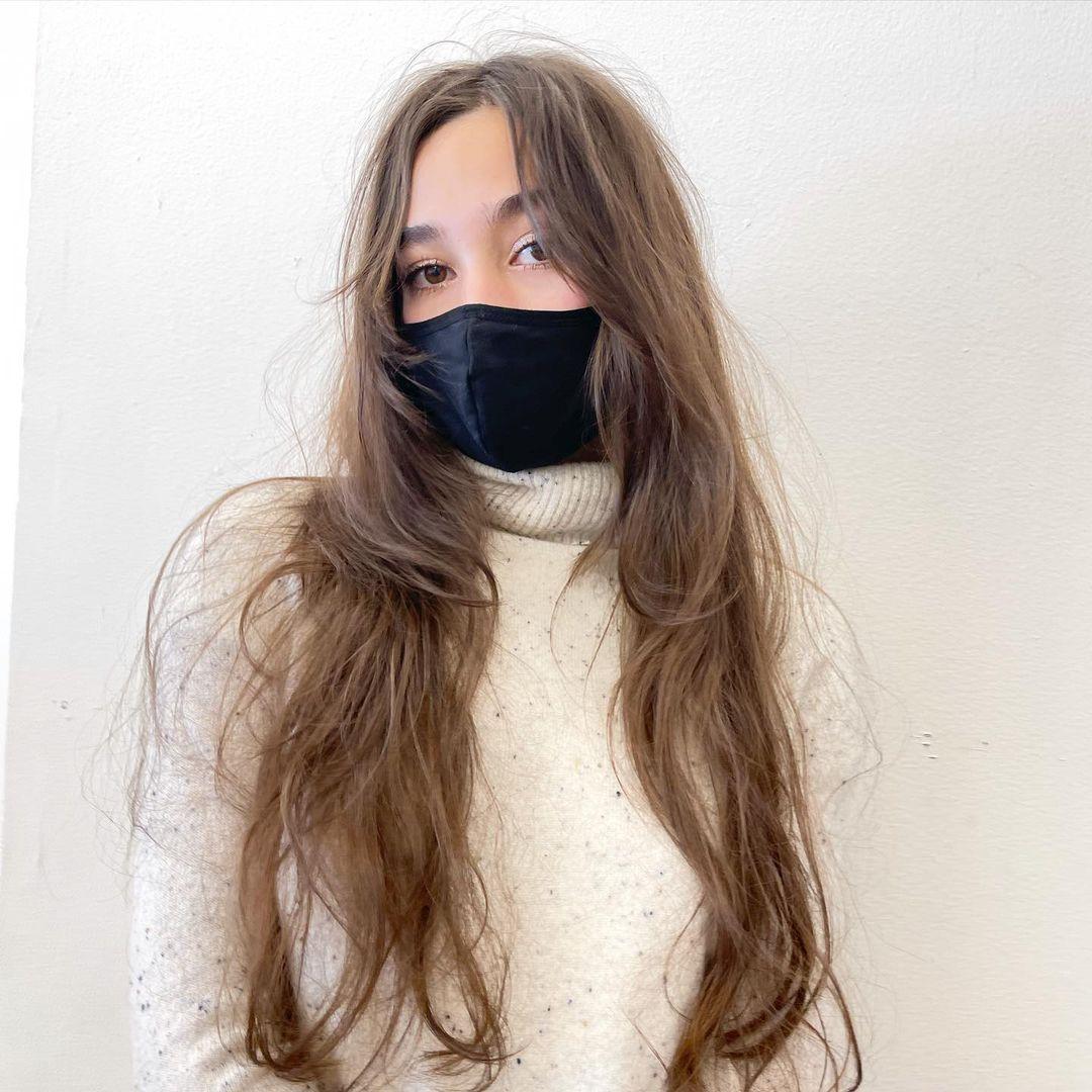 A 'Soft Waves Cascade' hairstyle featuring very long, light brown hair with loose, natural-looking waves, soft volume, and flowing layers, creating an effortlessly chic look with minimal styling. by @takeohair 1