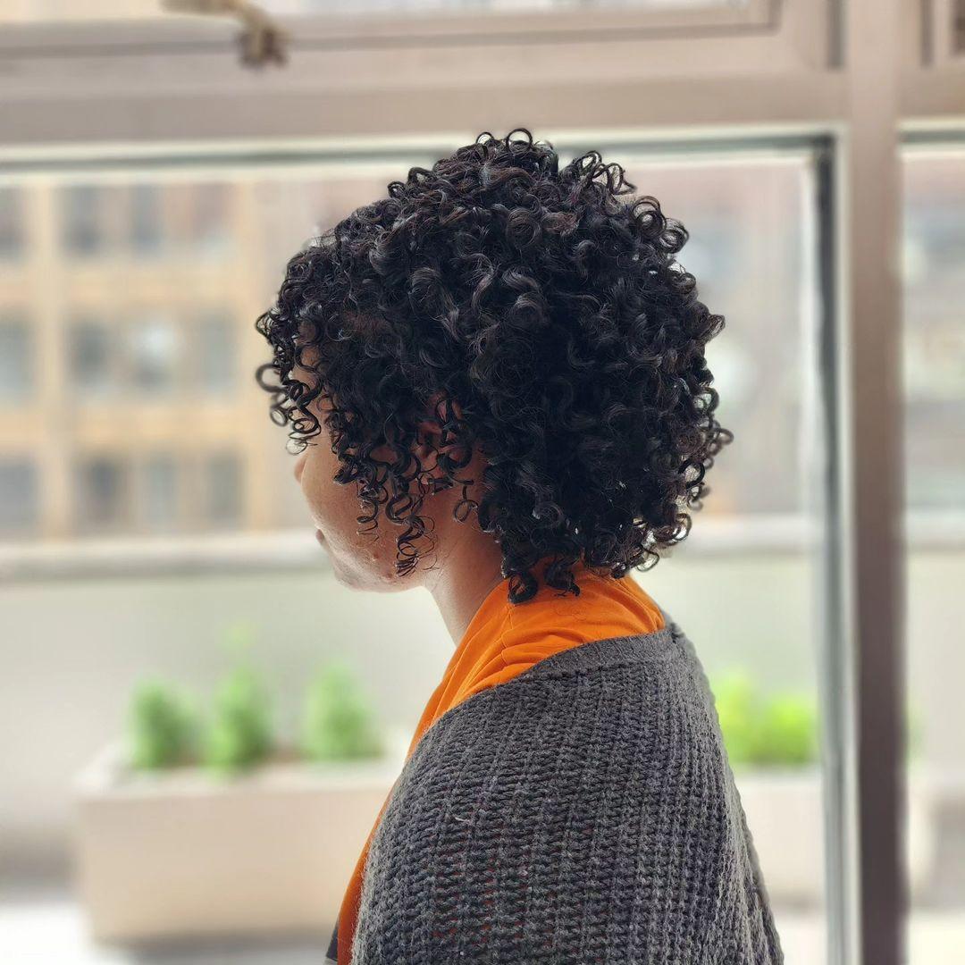 Medium-length, black, curly hair with defined, voluminous curls in a rounded shape, layered for added depth and bounce. 2