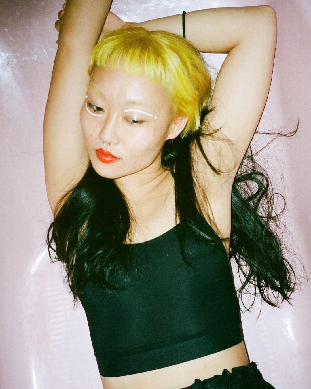 Edgy hairstyle with bright yellow blunt bangs and long black wavy locks, creating a bold contrast and a punk flair. by @takeohair  1