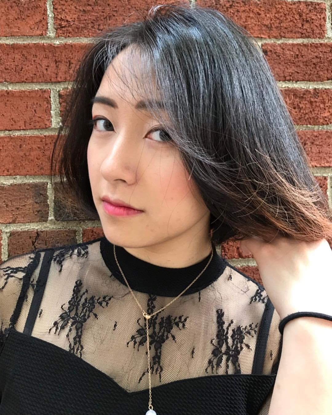 A sleek, medium-length, straight bob with an asymmetrical, side-parted design, featuring a deep, rich black color and a smooth, silky texture. 1