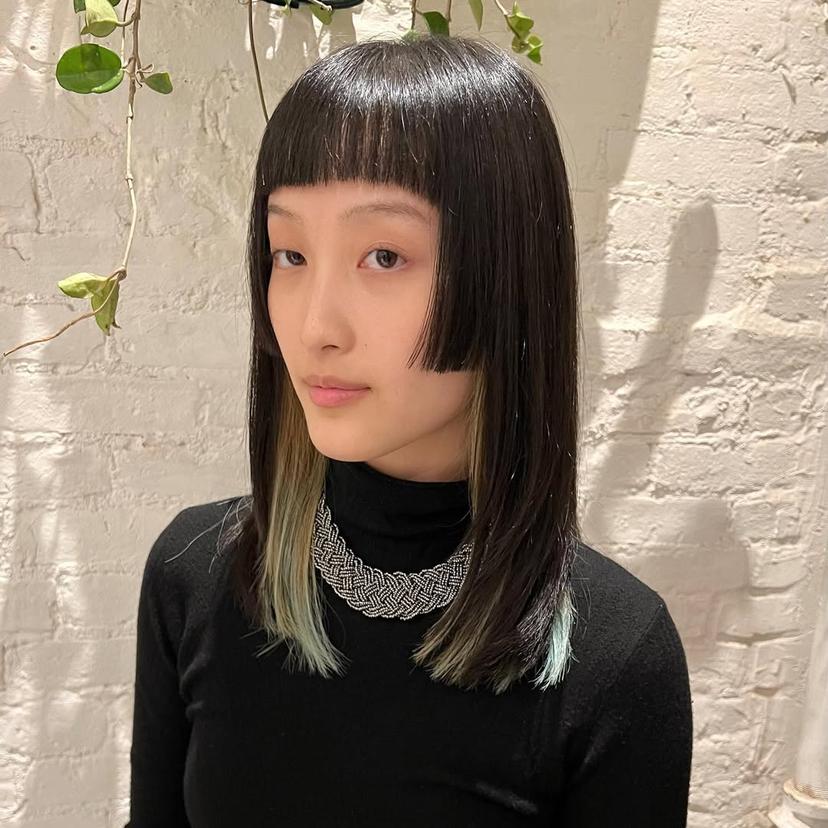 Box bob with blunt bangs and vibrant money piece highlights.
