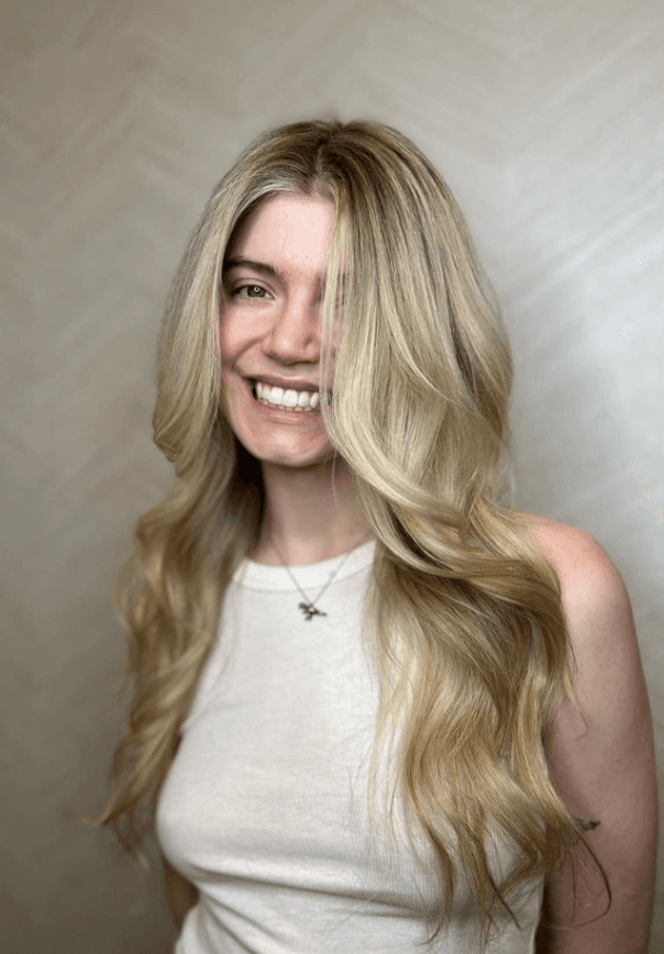 Very long, wavy blonde hair with golden highlights, soft waves, and loose curls forming a face-framing style.

 3
