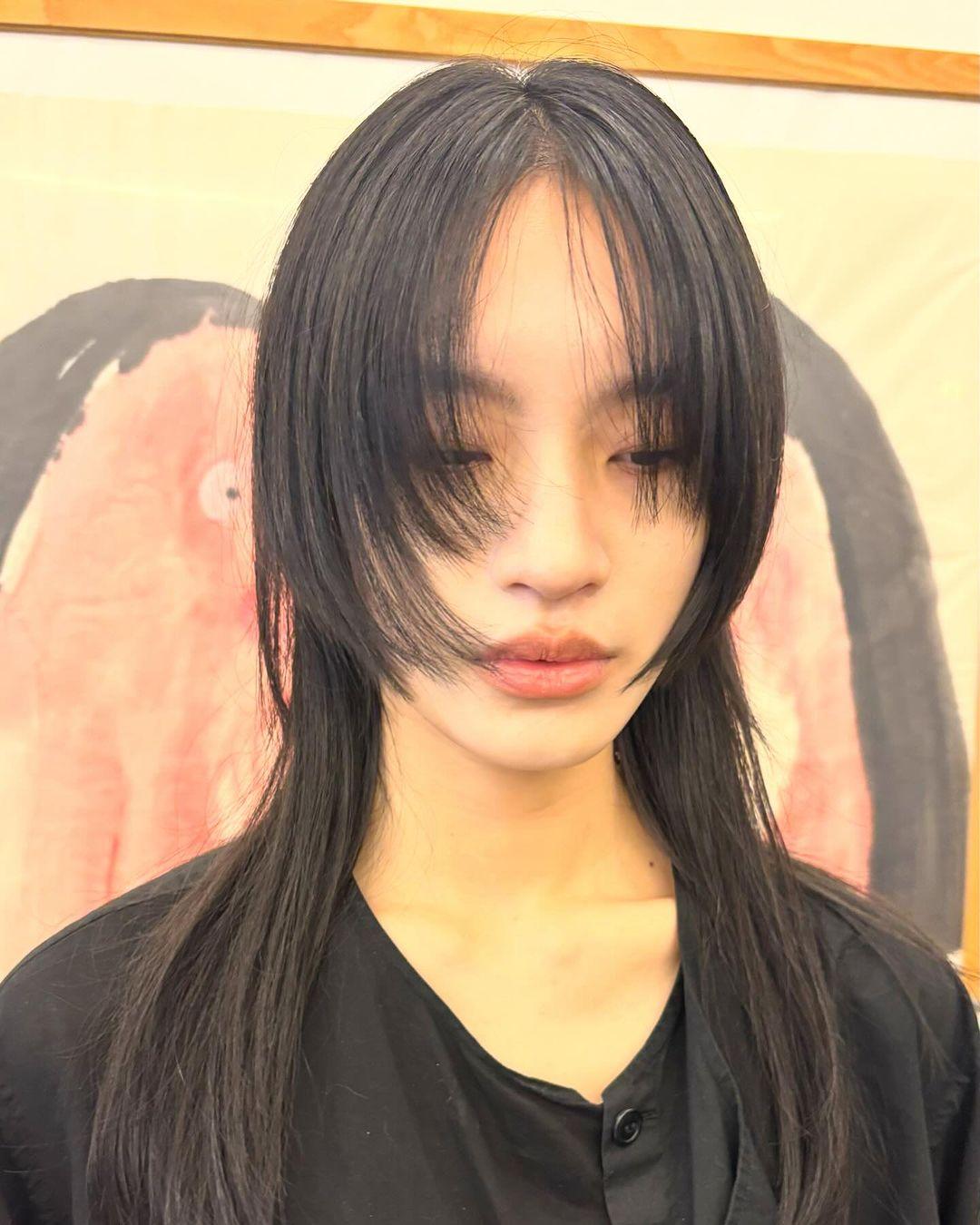 Sleek, straight black hair with medium-length, eye-grazing bangs and face-framing layers, creating a polished and modern look. Haircut by @takeohair 3