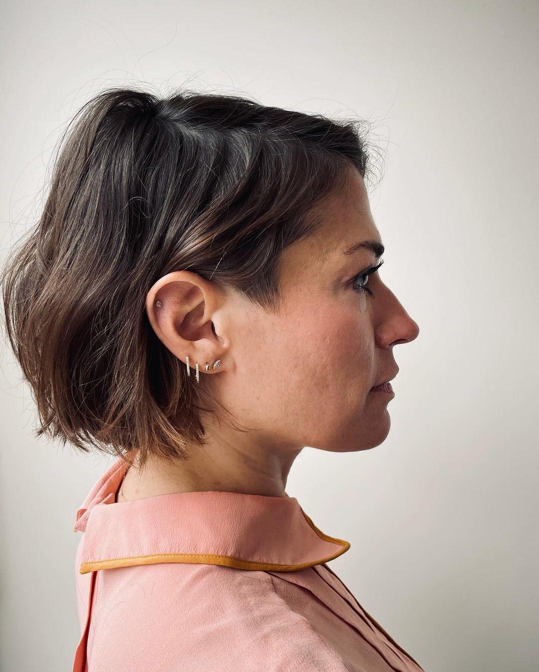 A short, wavy bob with a tousled, textured finish and subtle highlights for added depth. 2