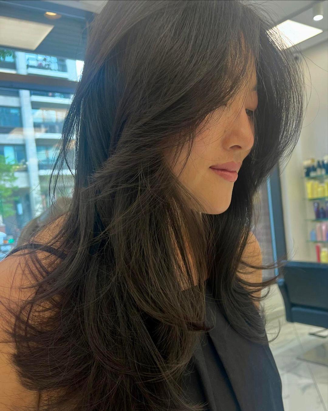 Long, straight, layered dark brown hair with a smooth and lustrous finish. 3