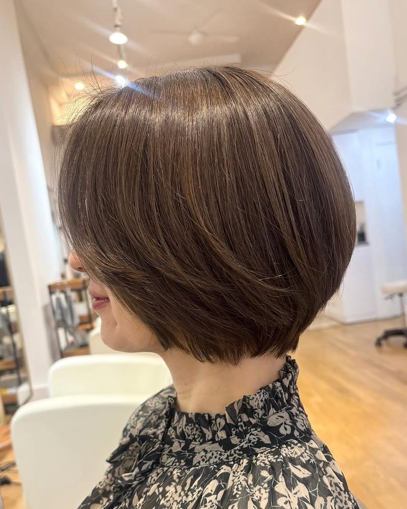 Classic stacked bob haircut with subtle layering, offering built-in volume for fine hair.