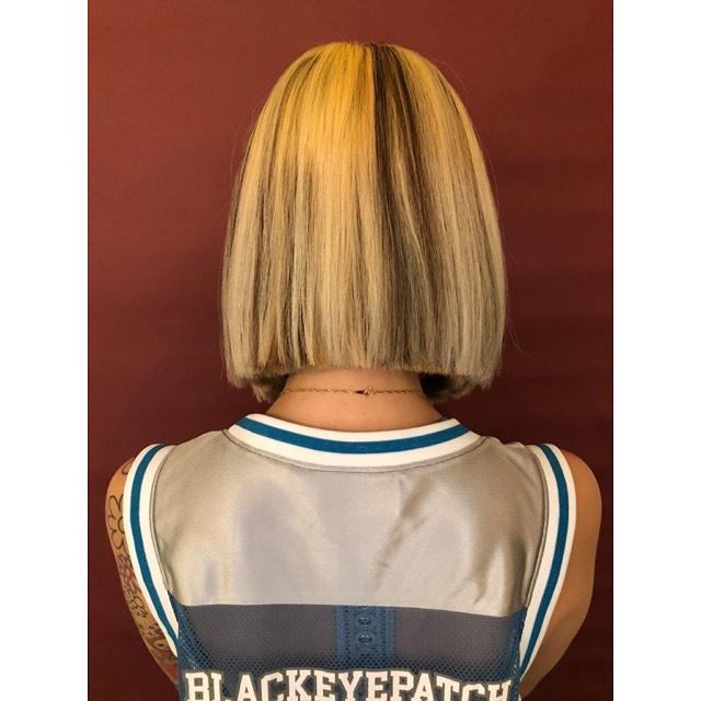 A medium-length, blunt bob with contrasting blonde and dark brown sections.