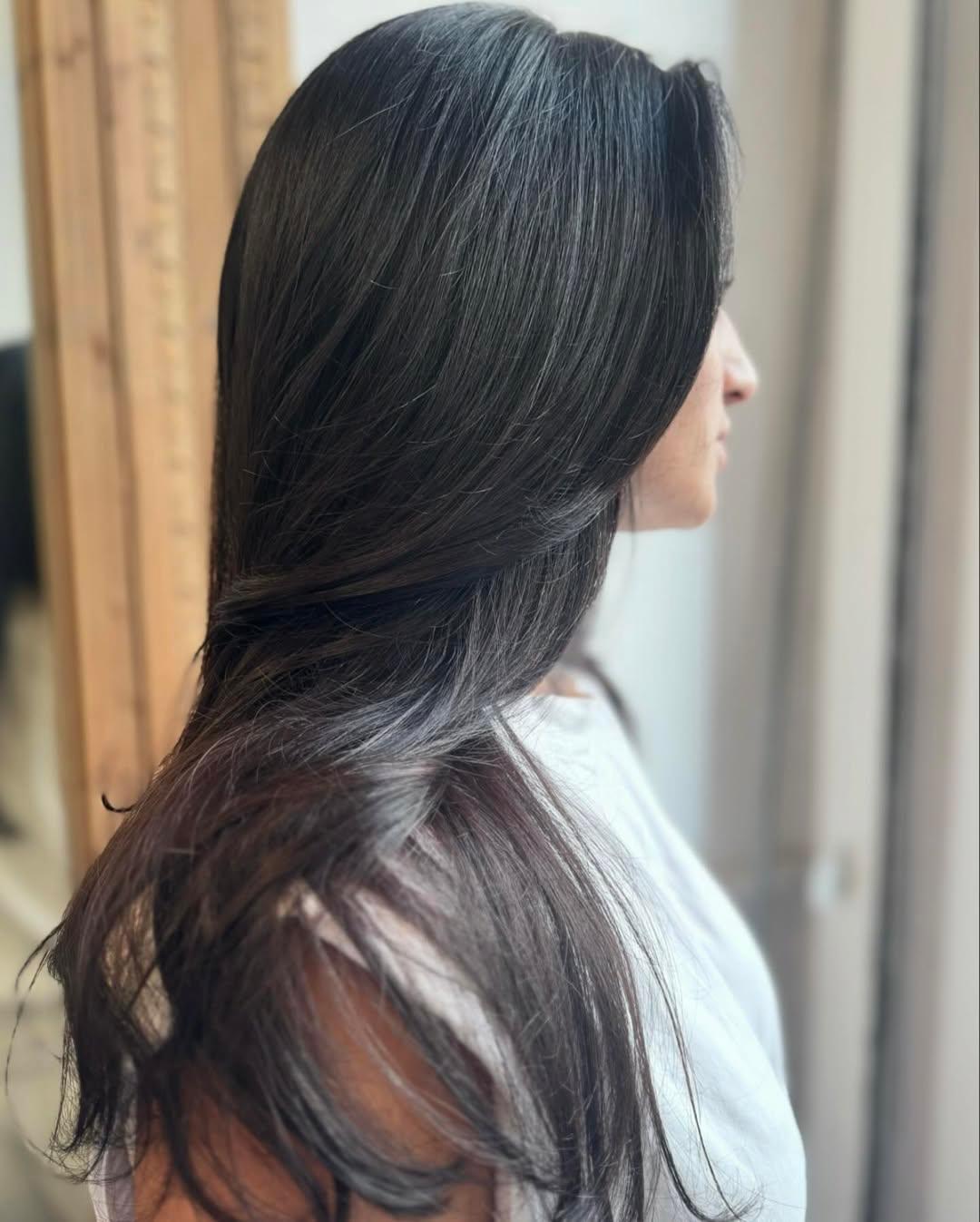 Long wavy hair with sleek layers and a side part, showcasing natural shine. 2