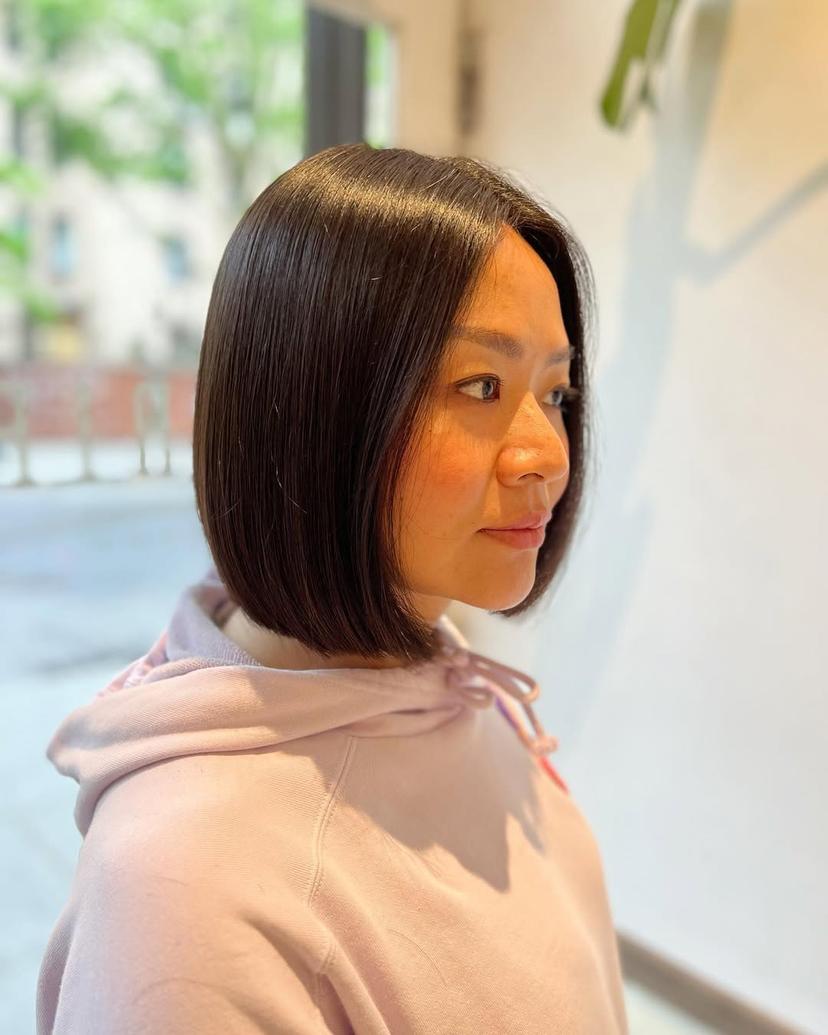 Sleek chin-length bob in black hair, styled in Manhattan, New York