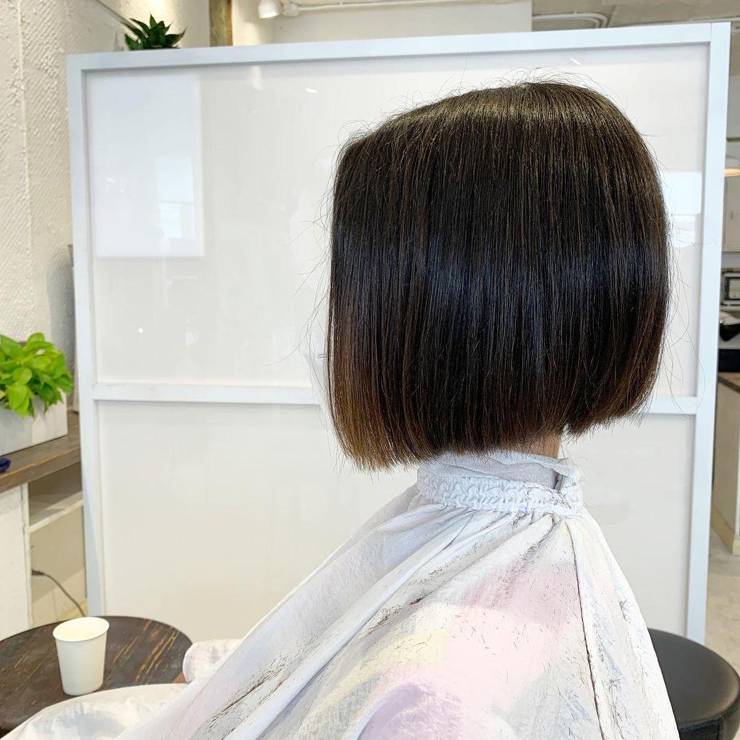 A sleek, straight, blunt cut bob with a glossy finish, characterized by short length and a precision line. 1