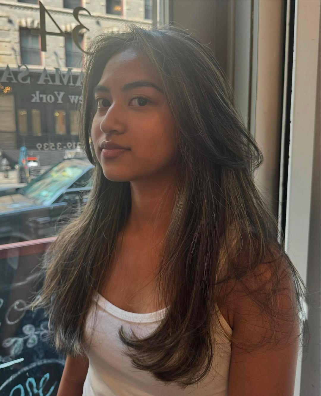 Long, straight, dark brown hair with ash blonde highlights, layered for volume with a sleek finish. 5
