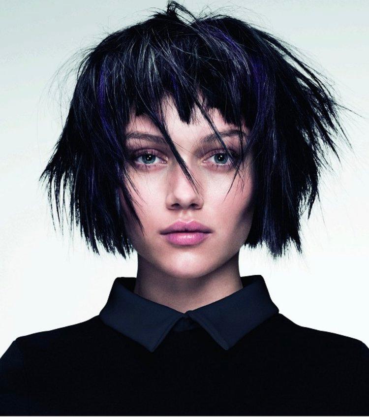 Edgy choppy bob with baby bangs and a textured finish.