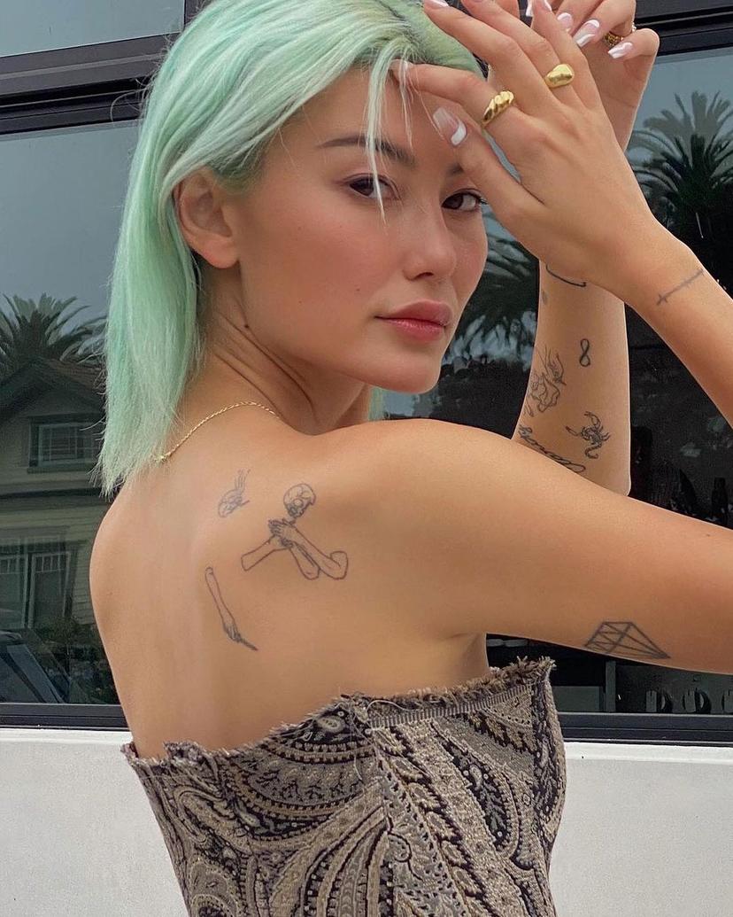 A chic, straight bob cut dyed in pastel mint green, offering a sleek and modern look.