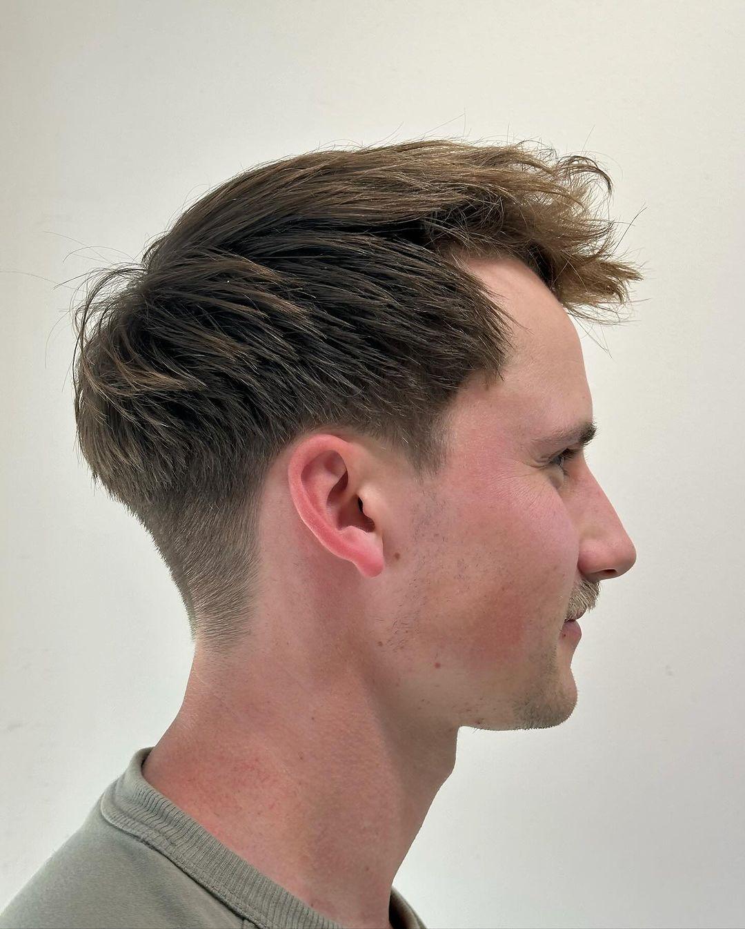 A textured tousle with a natural movement and soft lift on the top, complemented by an undercut side and tapered back. 2