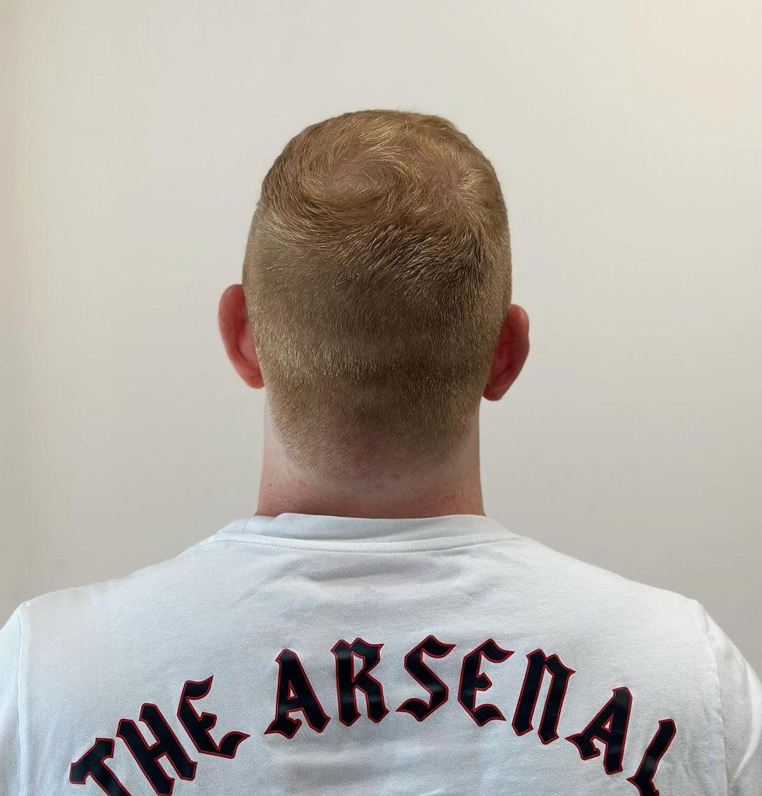 Short, sleek, and straight with a tapered fade and a subtle quiff on top, finished with a classic side part. 2