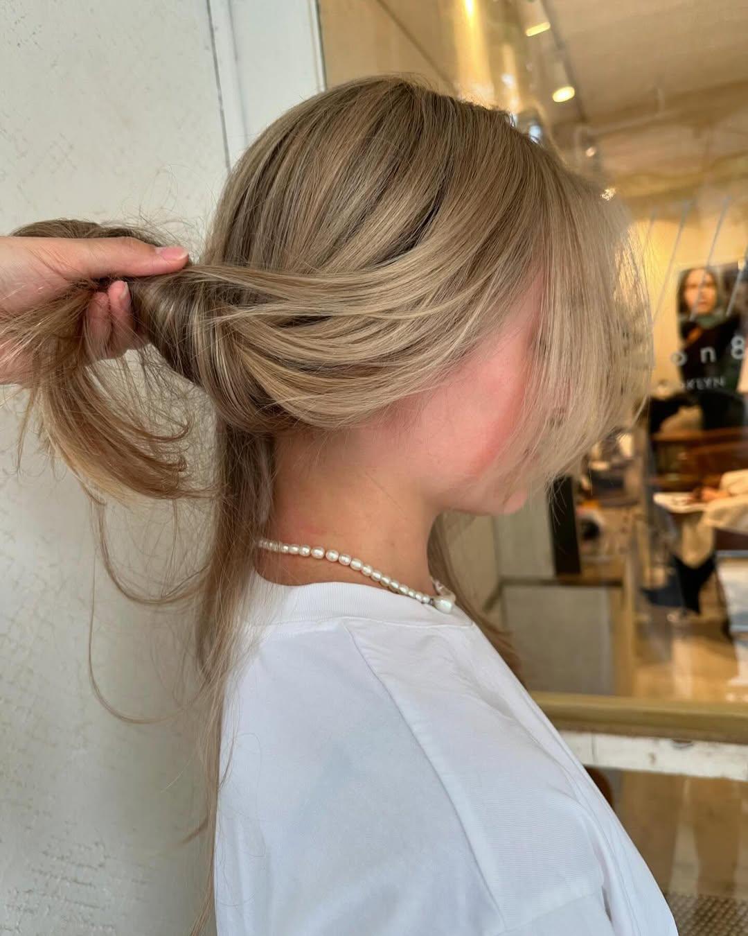 Long, wavy, blonde hair with side-swept bangs and layered waves, featuring natural volume and a beachy texture. 2