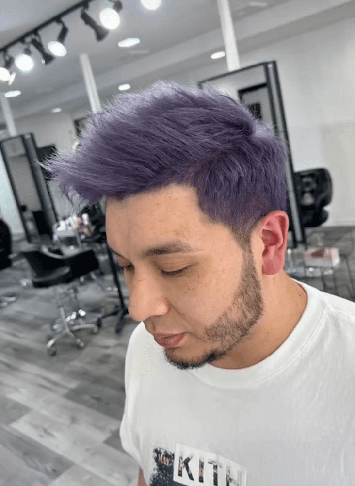 A vibrant short hairstyle with a purple color. The hair is straight and has a textured top, styled upward with a spiky effect, combined with neat side fades. 2