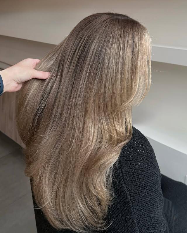Long layered bronde balayage with soft layers and face-framing pieces