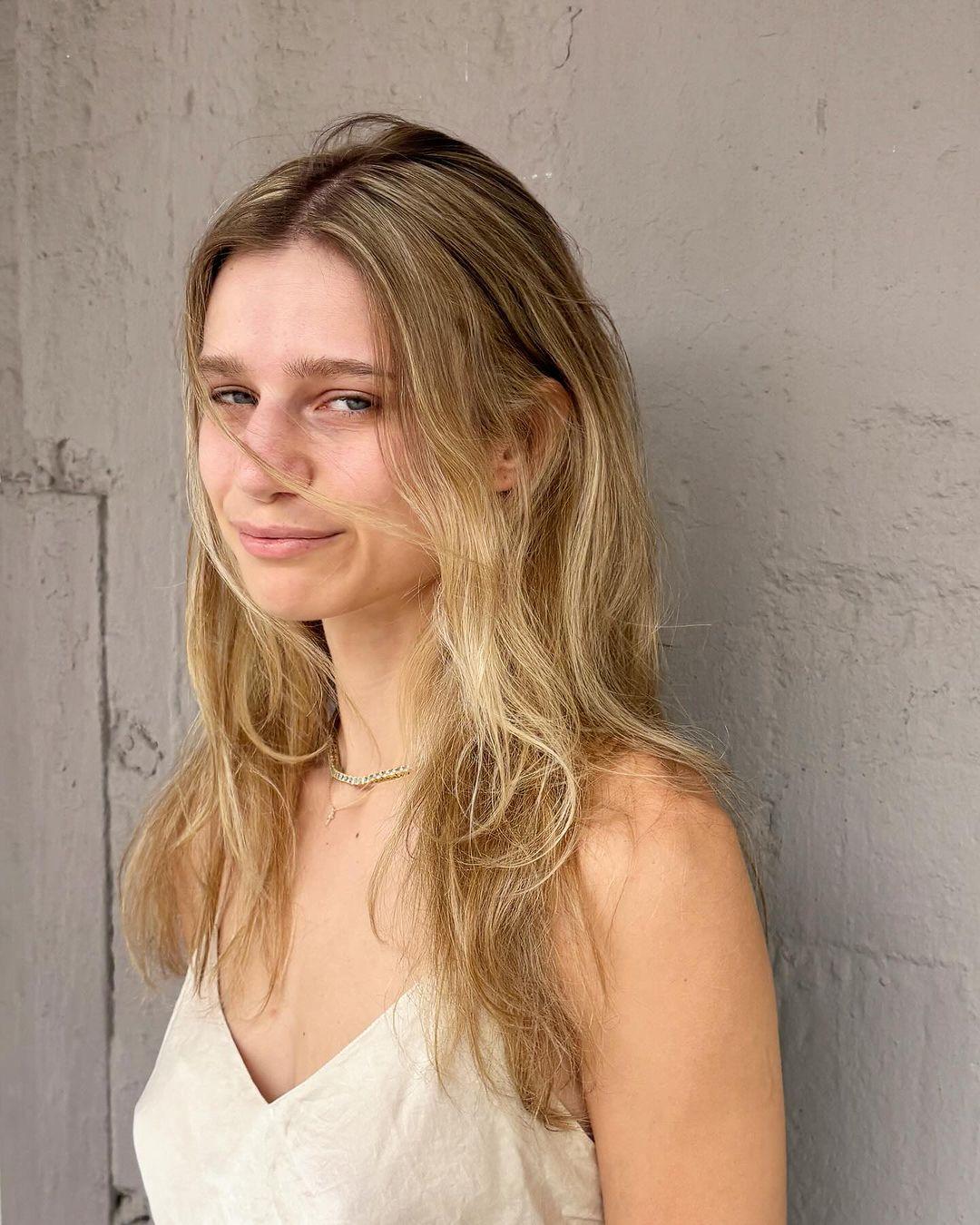 Natural, tousled long wavy blonde hair with sun-kissed highlights and a carefree, beachy vibe. 4