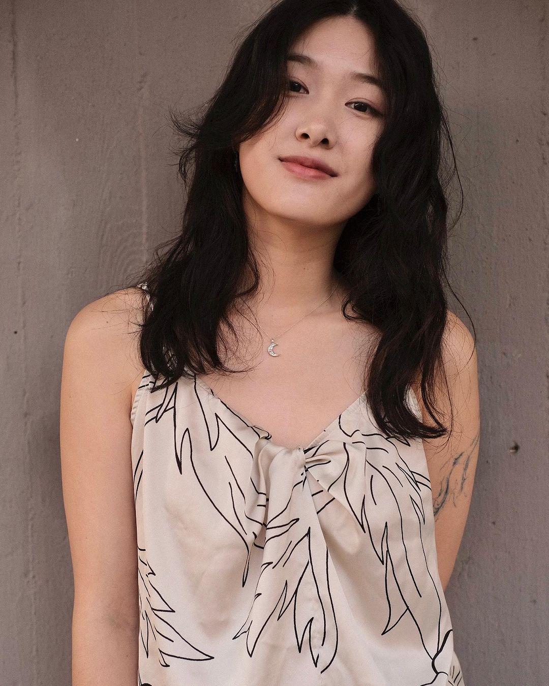 Long, wavy black hair with face-framing layers and a loose, natural texture. 3