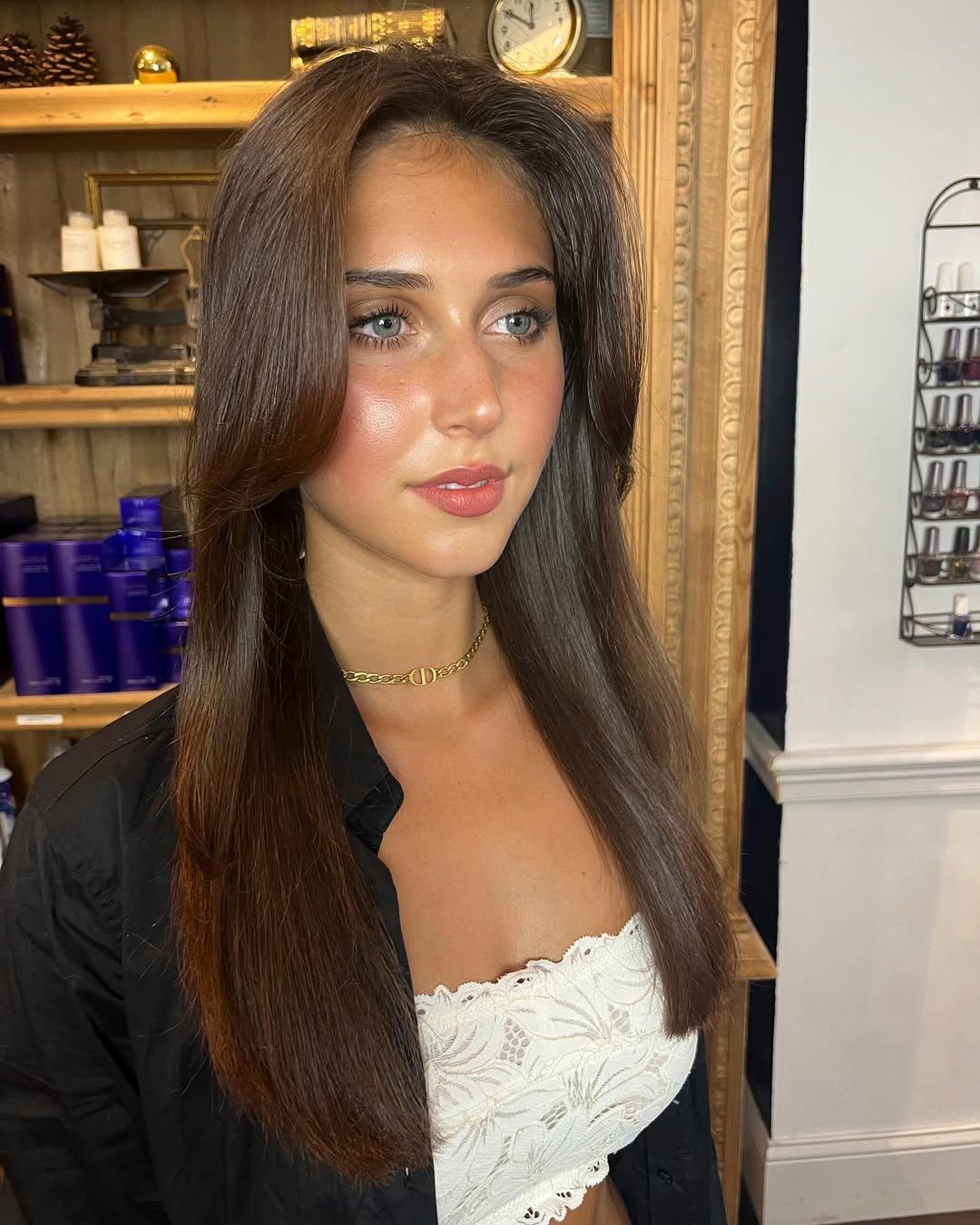 Long, chestnut brown straight hair with a middle part, featuring face-framing layers and a glossy finish. 2