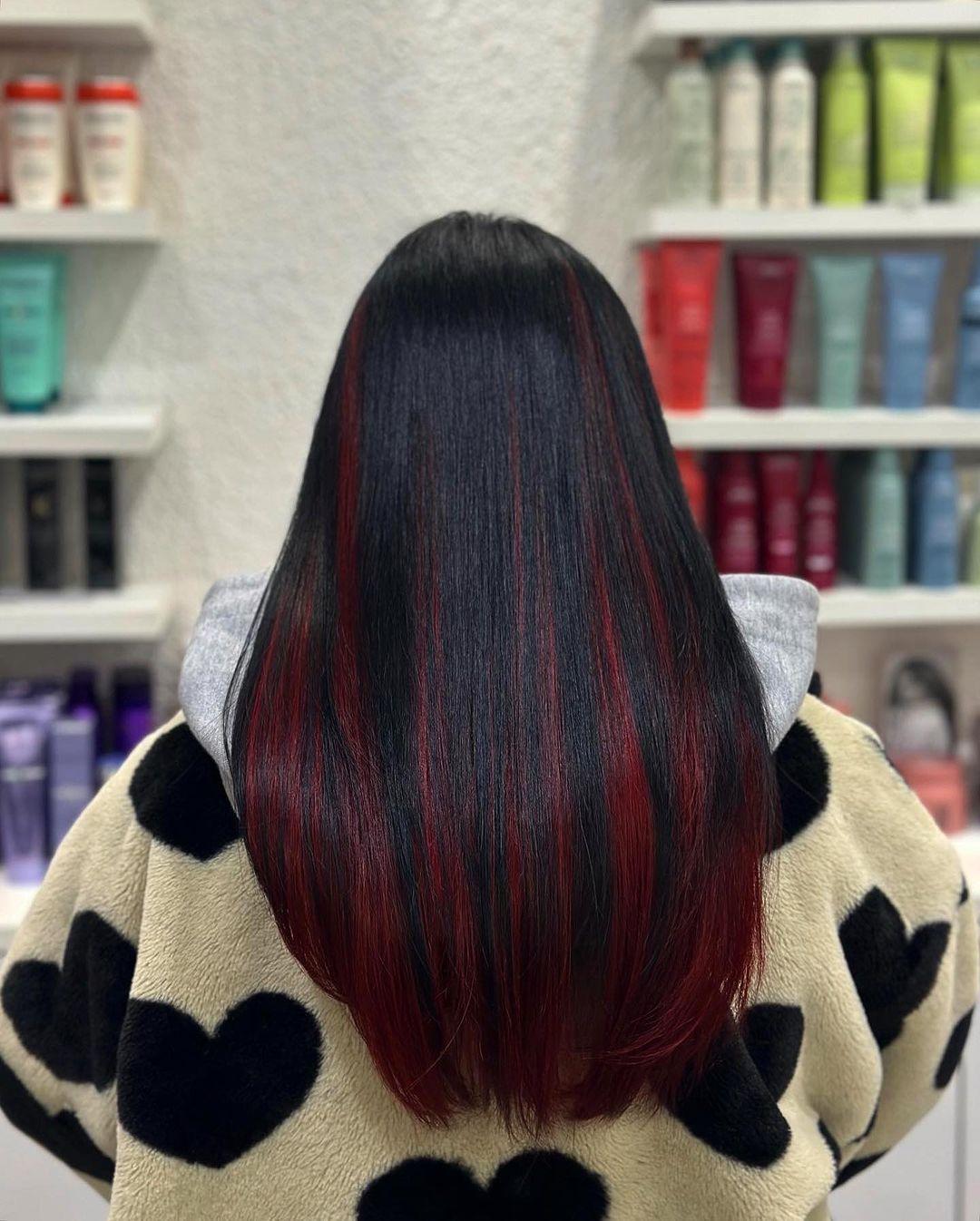 Sleek Straight black hair with red dye underneath for a peekaboo look. 3