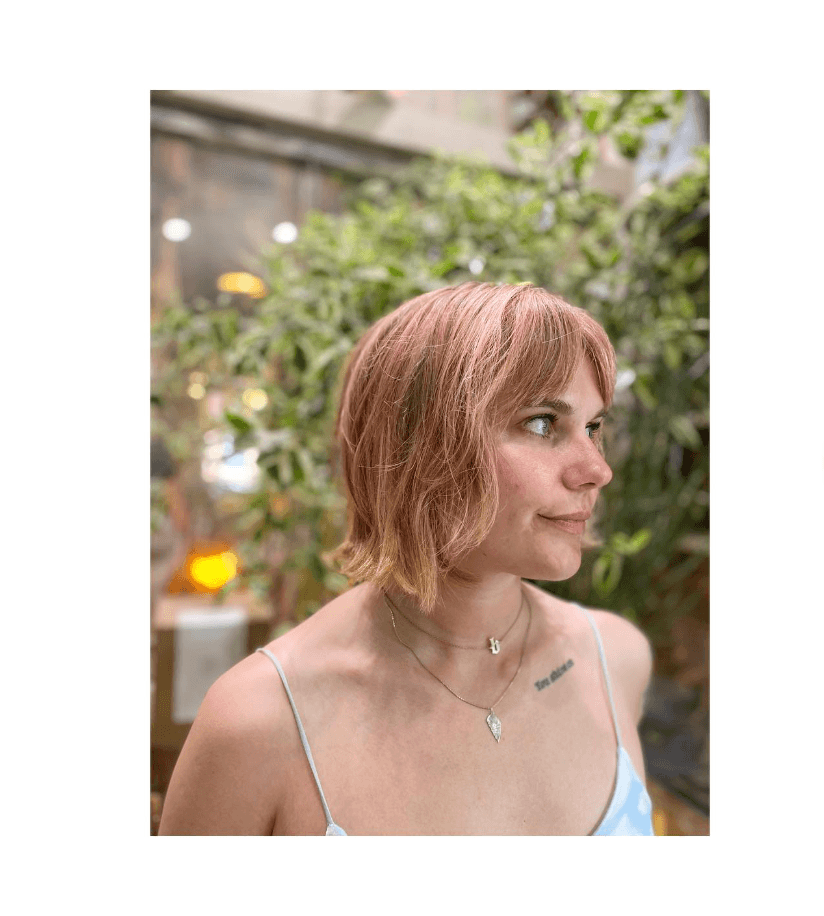 Short, blunt bob with textured ends and baby bangs.
