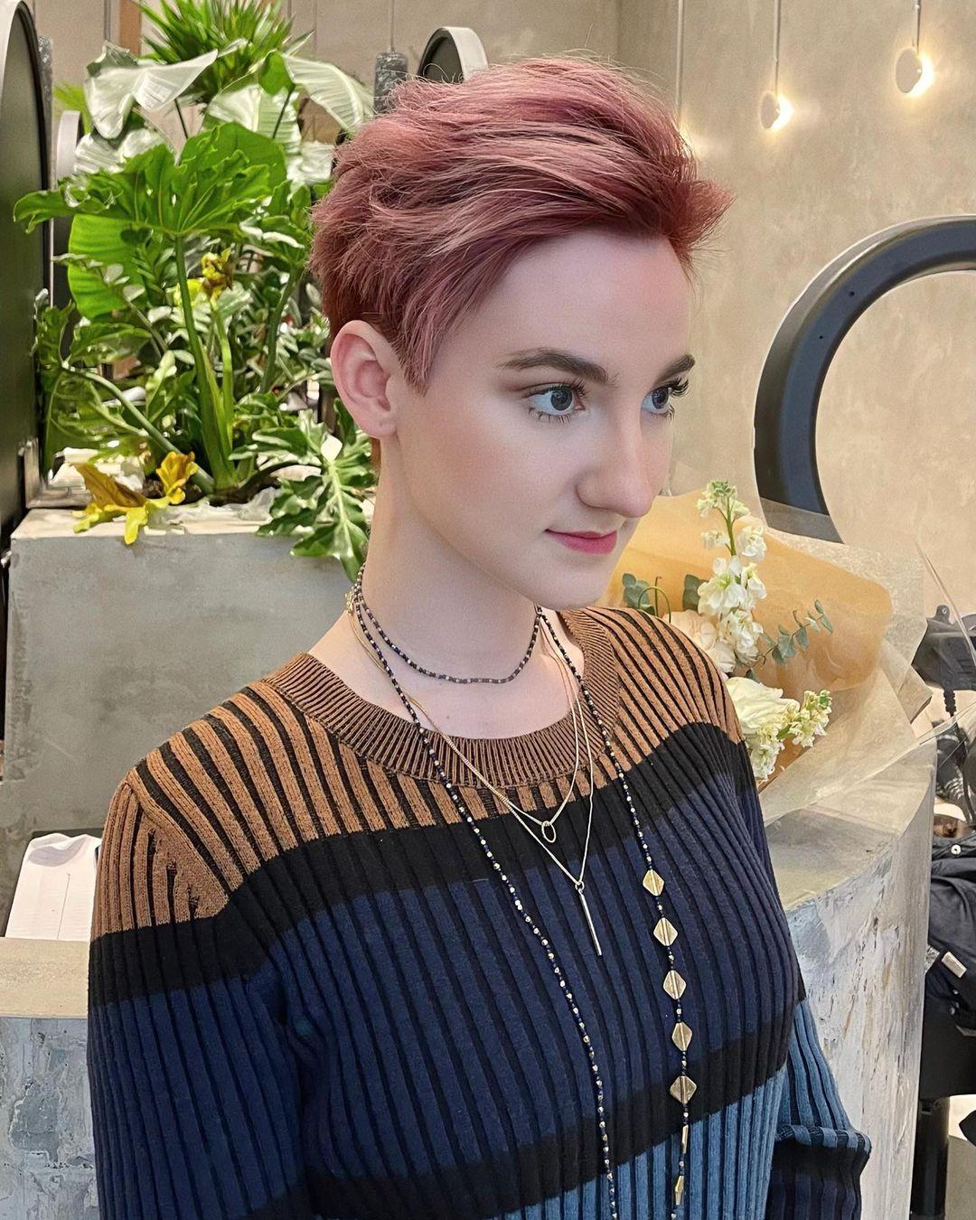 A short, wavy pixie with textured layers, highlighted by rose gold and pink tones. The sides and back are tapered, while the top is left slightly longer for added volume and movement. 🫘Hair by @kelvin_ly1011 🫘 3