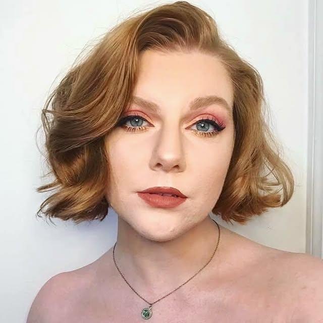 A short, wavy bob styled with deep vintage Hollywood waves and a side part.
