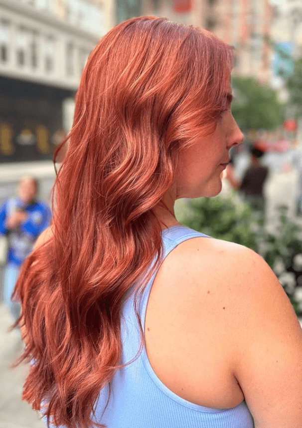 Long, auburn hair with soft, voluminous waves and a middle part, featuring subtle layers for added movement.

Color by @simabeautynyc
Cut and style by @juliamannino_hair
 2