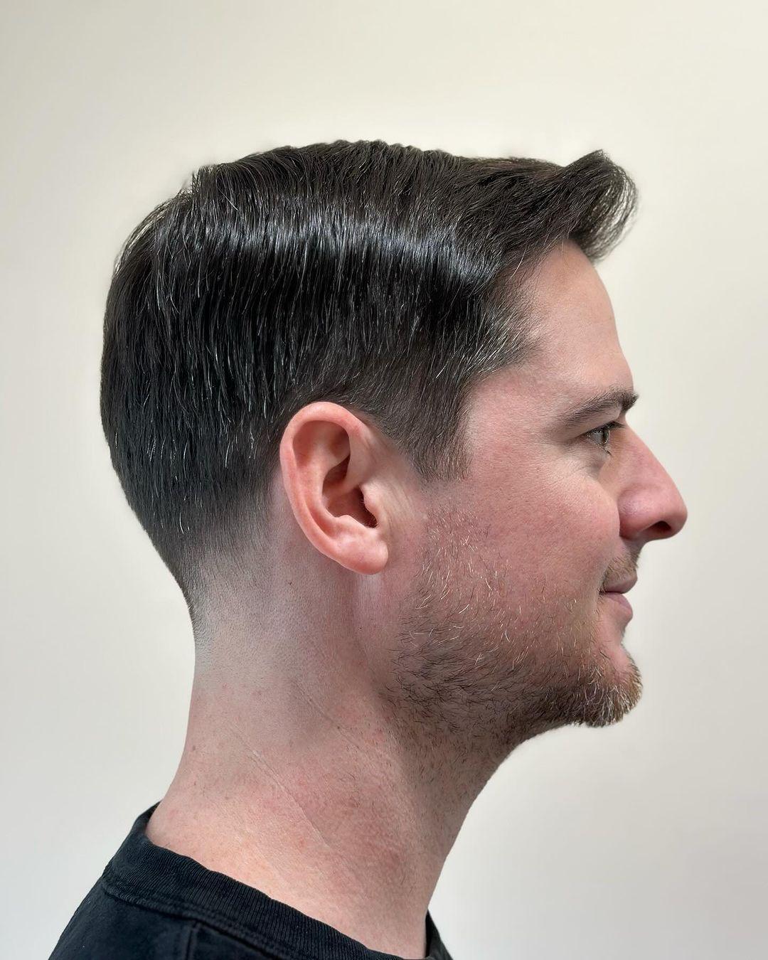 A sophisticated short haircut with a classic side part and tapered fade, ideal for a polished and professional look. 1