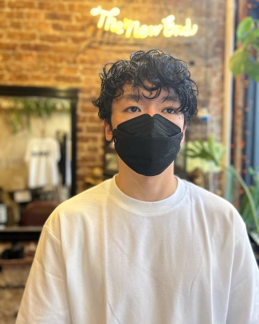 Male short textured crop with defined, tight curls.