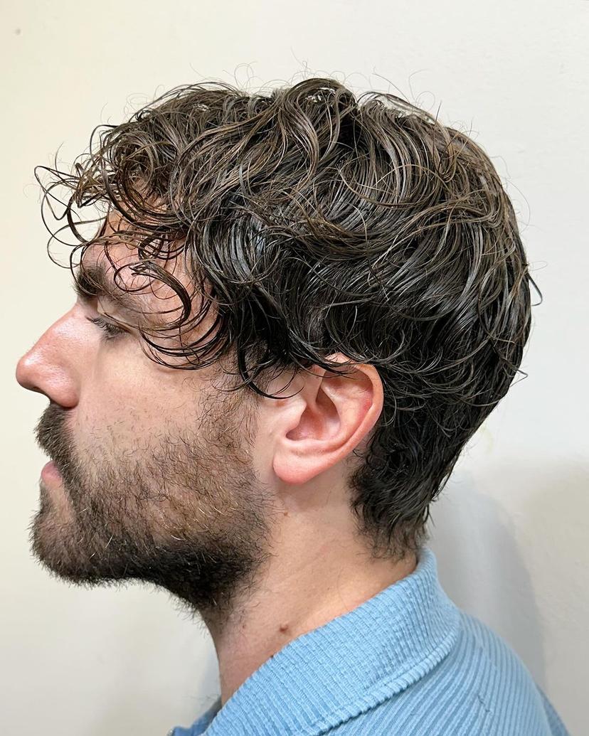 Medium-length wavy brown hair with natural texture, lightly layered for a casual look.