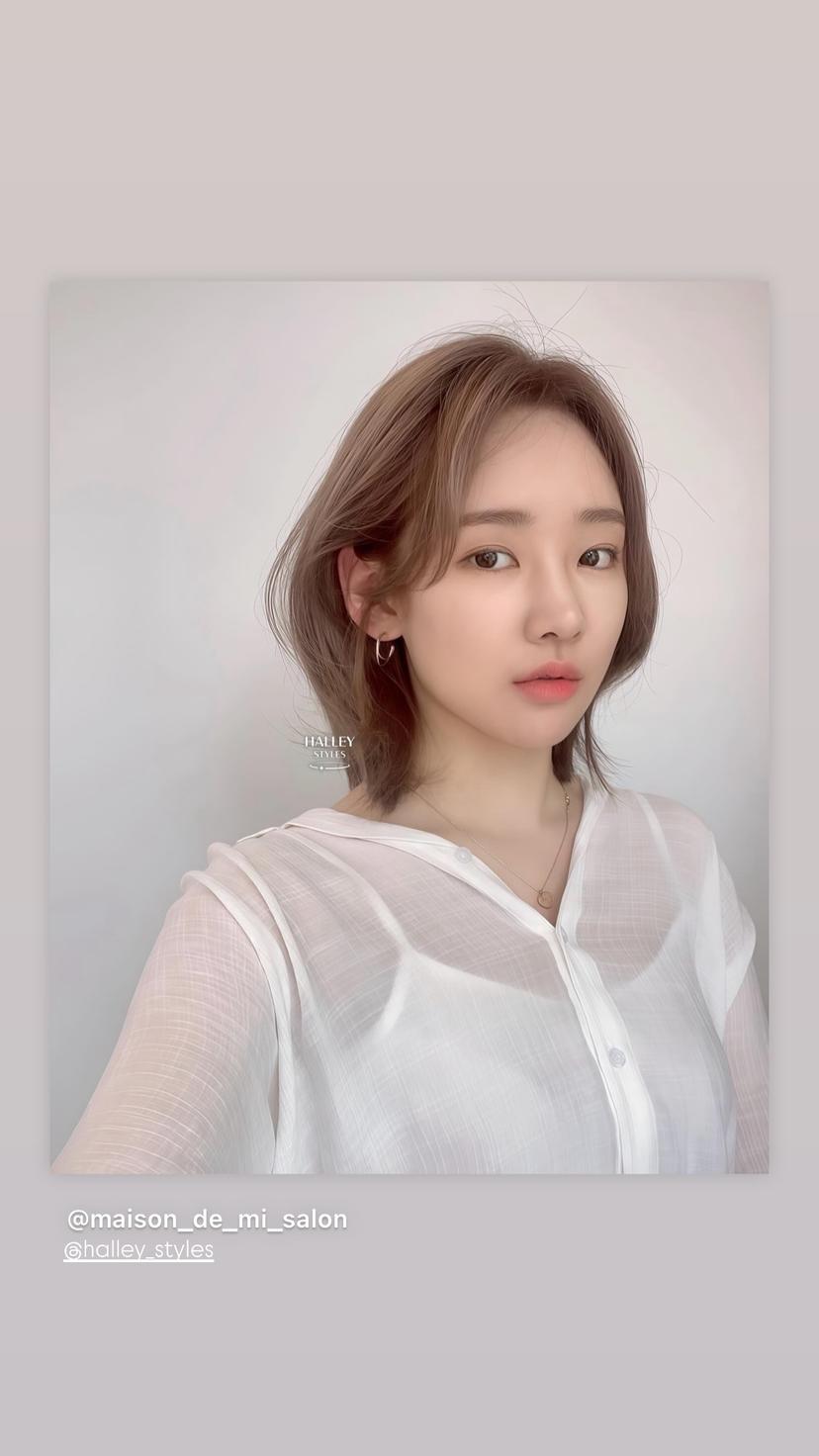 Modern bob with textured ends and soft, airy bangs.