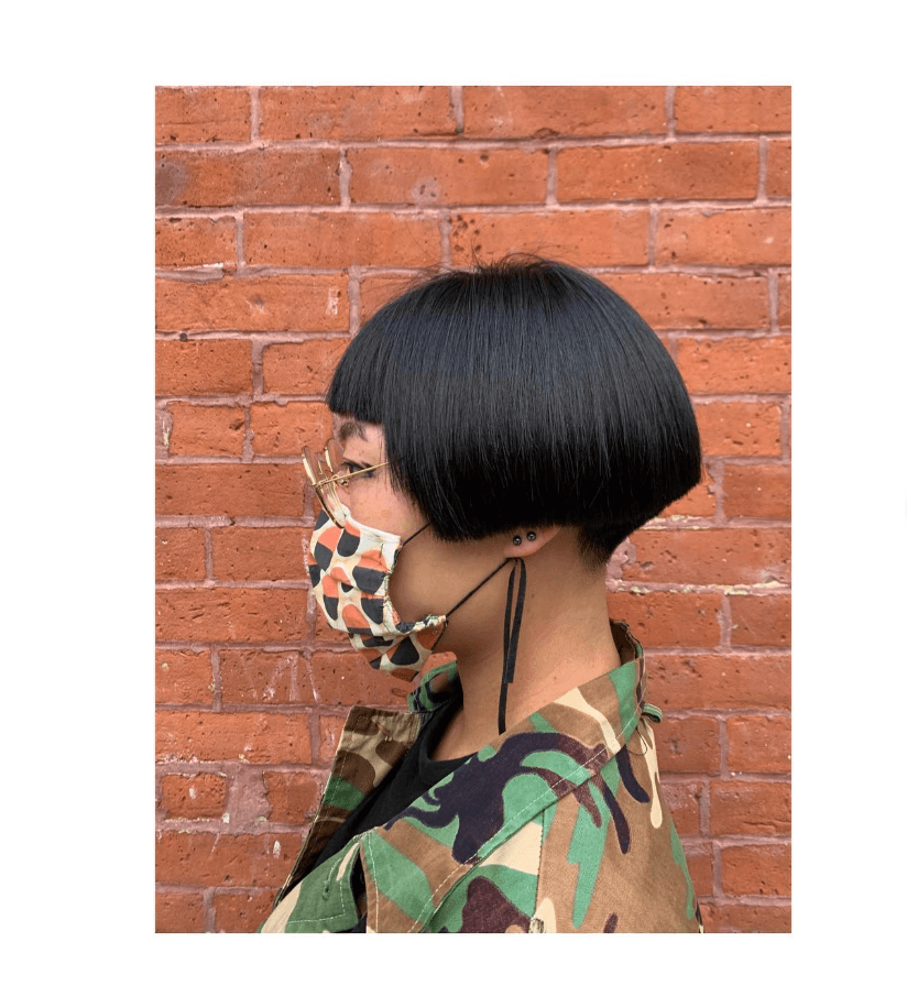 Woman with a sleek, edgy blunt bob haircut, a prominent 2025 hairstyle trend.