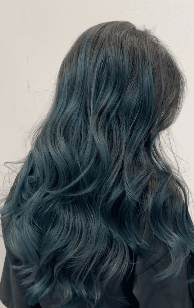 Voluminous, long dark teal waves with subtle black gradients.