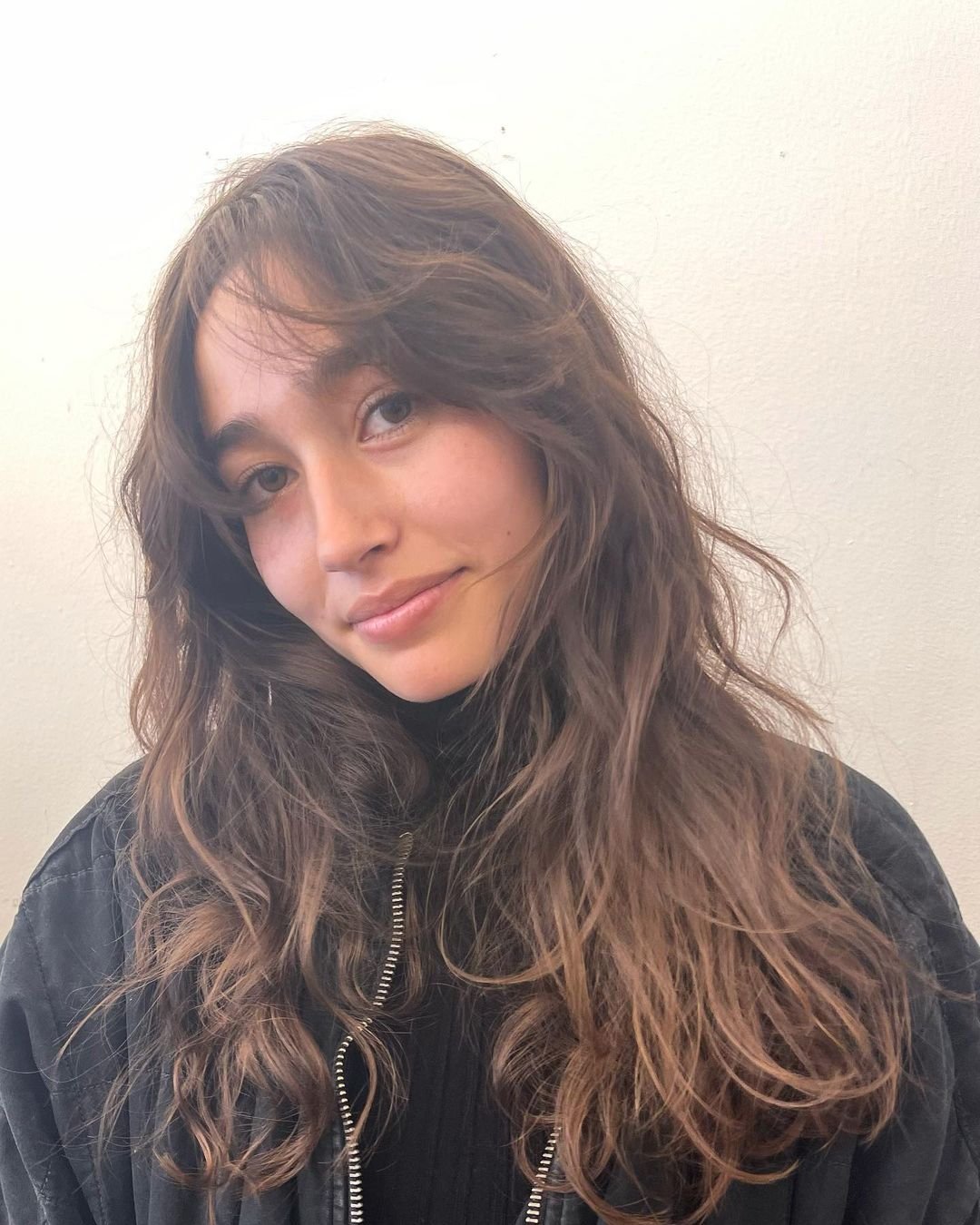 Long, wavy brown hair with natural highlights, featuring messy waves, soft layers, and face-framing tendrils. 2