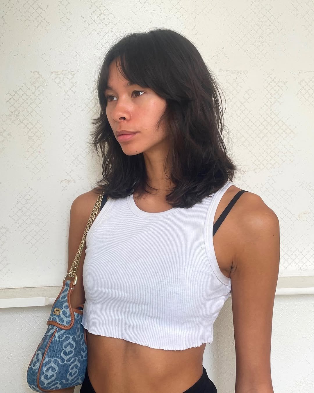 A casual medium-length cut with natural waves, soft layers, and curtain bangs, creating a modern and laid-back style. 3