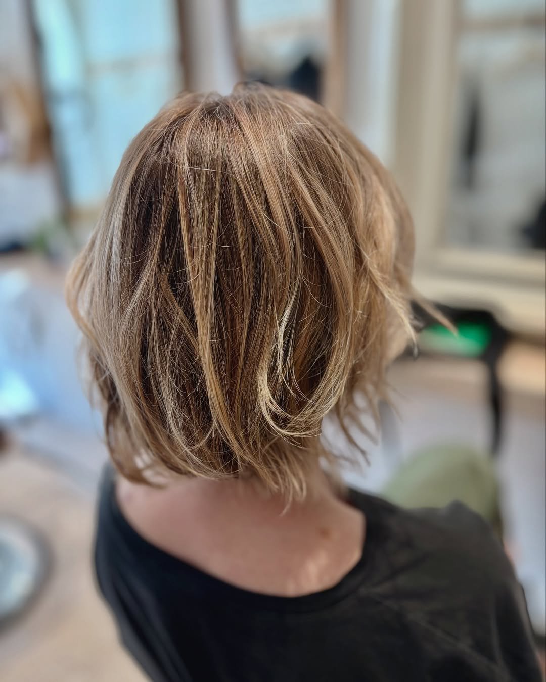 A short, layered bob with textured ends and subtle highlights. 2